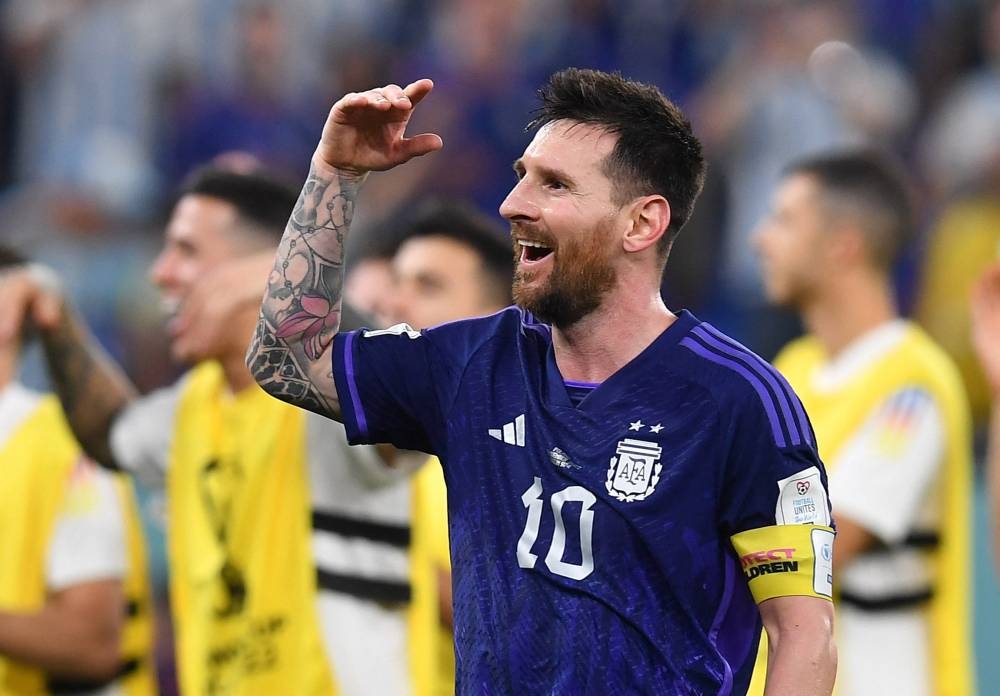 Soccer Football - FIFA World Cup Qatar 2022 - Group C - Poland v Argentina - Stadium 974, Doha, Qatar - November 30, 2022 Argentina's Lionel Messi celebrates after the match as Argentina qualify for the knockout stages REUTERS/Jennifer Lorenzini
