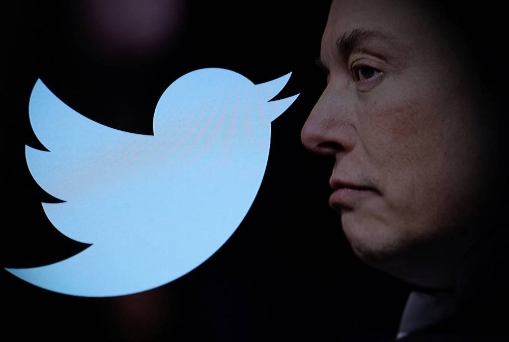Twitter logo and a photo of Elon Musk are displayed through magnifier in this illustration taken October 27, 2022. REUTERS/Dado Ruvic/Illustration